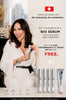 Swiss National Day promotional ad featuring a smiling woman in a white robe holding a skincare tube, with text offering a bundle of 4 bio serums plus a free high-performance CC cream SPF 30. Four silver serum tubes and one white tube are shown at the bottom right.